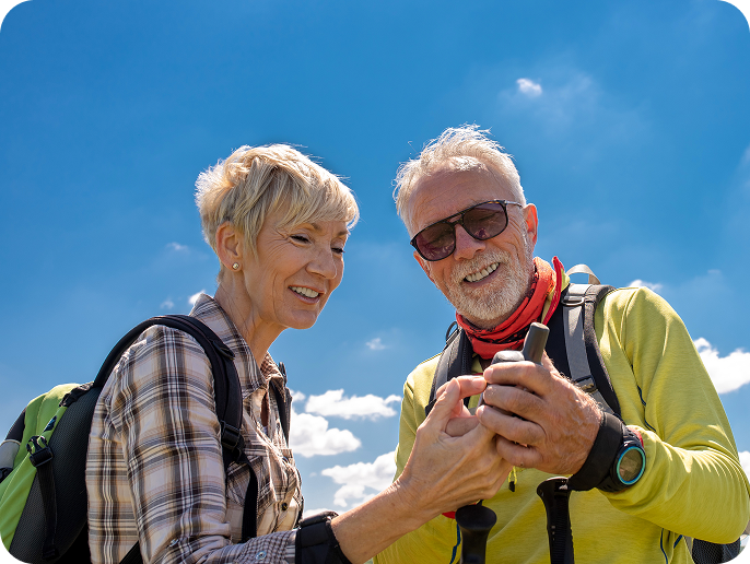 Happy senior couple navigating outdoors